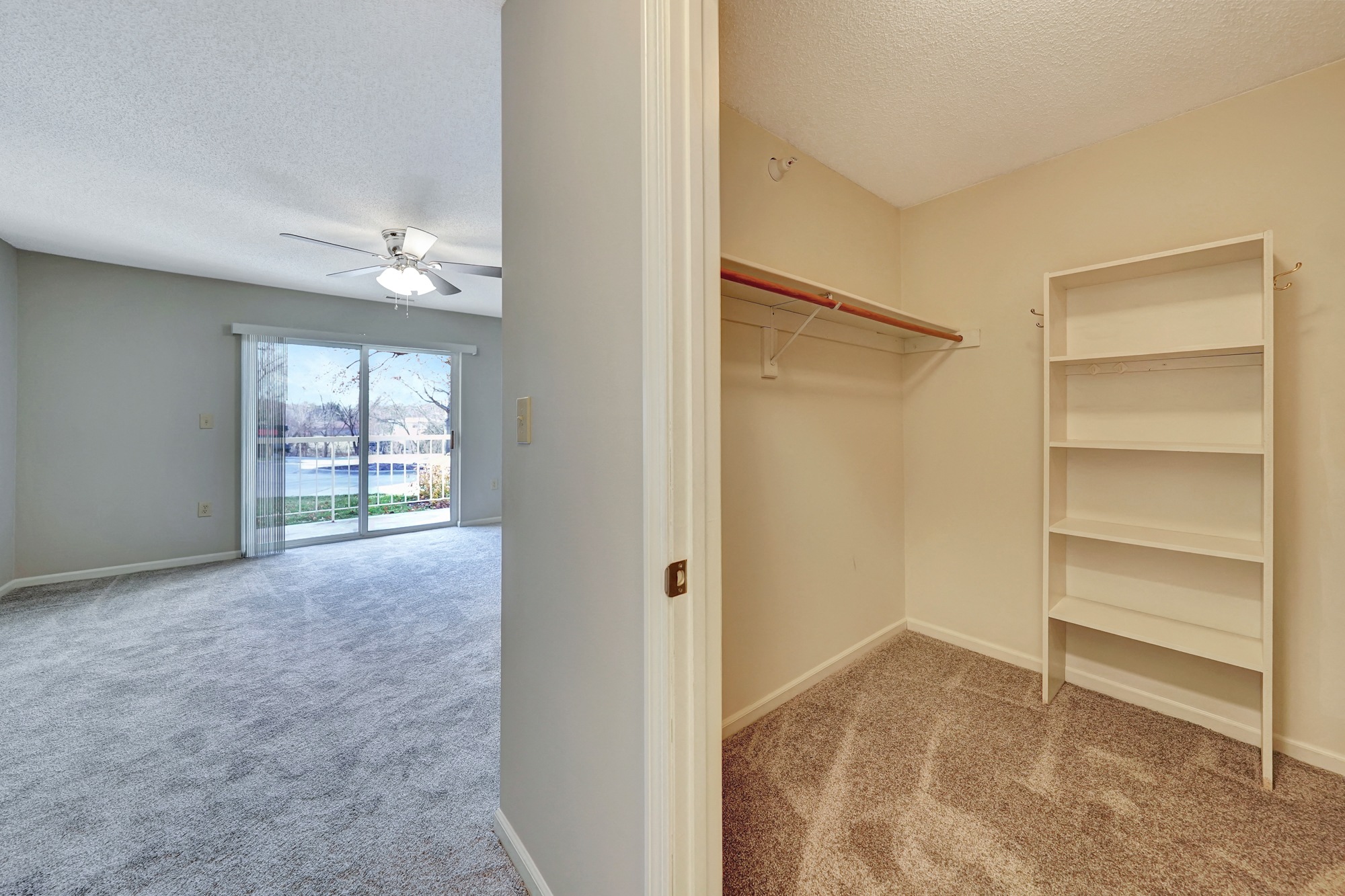 an empty bedroom with a closet and a ceiling fan
